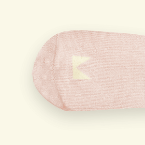 Close-up of Blush Organic Cotton Baby Socks featuring a gentle pink shade and the Mosey logo above the toes.