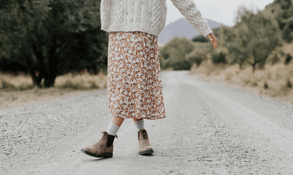 Wearing warm and comfortable womens merino socks for winter while walking on a gravel road.