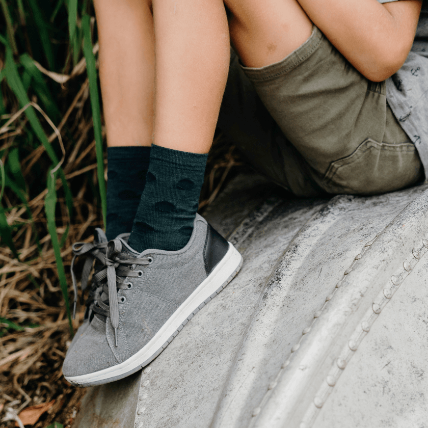 child wearing merino wool socks crew green with blue spots nz