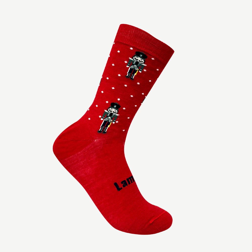 Red sock with white spots with nutcracker design
