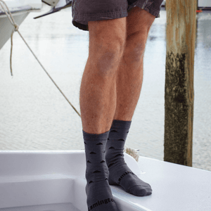 man on boat wearing merino wool crew socks nz